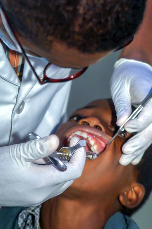 Adminstering freezing a patient during a dental procedure — representing the need for access and equity in Black dental care.