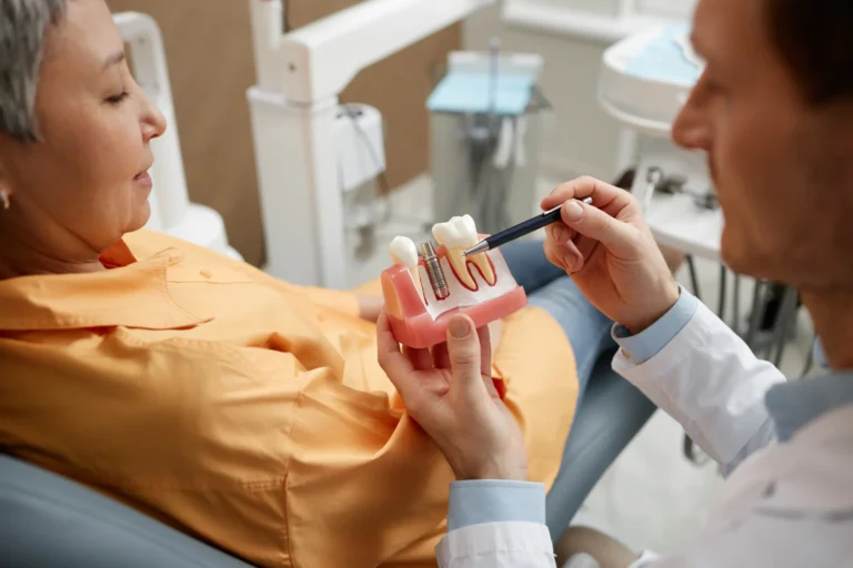 closeup-of-male-dentist-explaining-dental-implant-2025-03-08-15-55-23-utc
